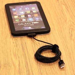 Long colied sync cable connected to Galaxy Tab